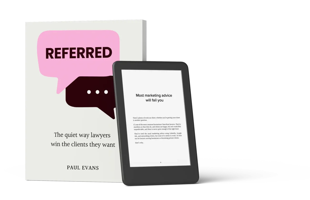 Referred shown on an e-reader beside the paperback.