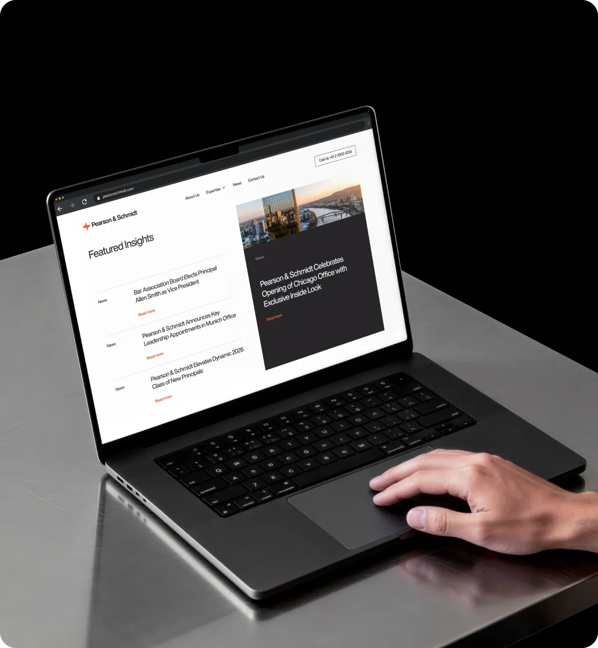 Laptop showing a TLM-built law firm website with featured posts